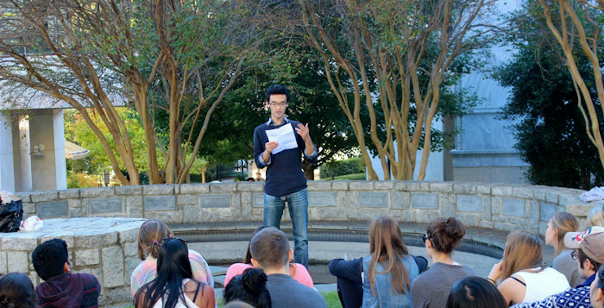 Last Friday at Black Dog, a poetry reading hosted by Emory student literary collective The Pulse, College senior Eugene Ahn (center) addressed the difficulties of growing up a minority through his poetry. | Photo by Julia Munslow/Staff