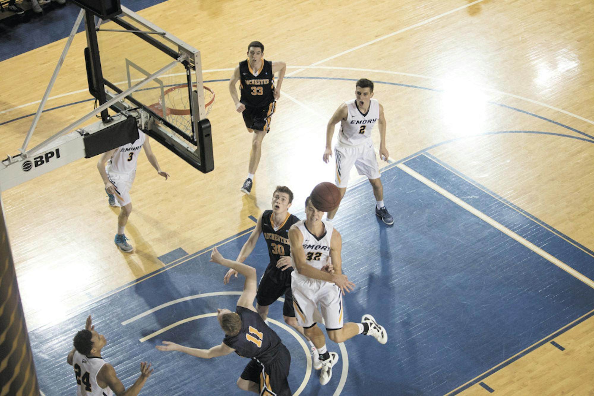 Senior forward Austin DaGue blocks a shot from Rochester senior guard Sam Borst-Smith in Emory's 63-62 victory. Hague contributed an impressive 22 points on the afternoon. Photo courtesy Nafimul Huda/Senior Staff.