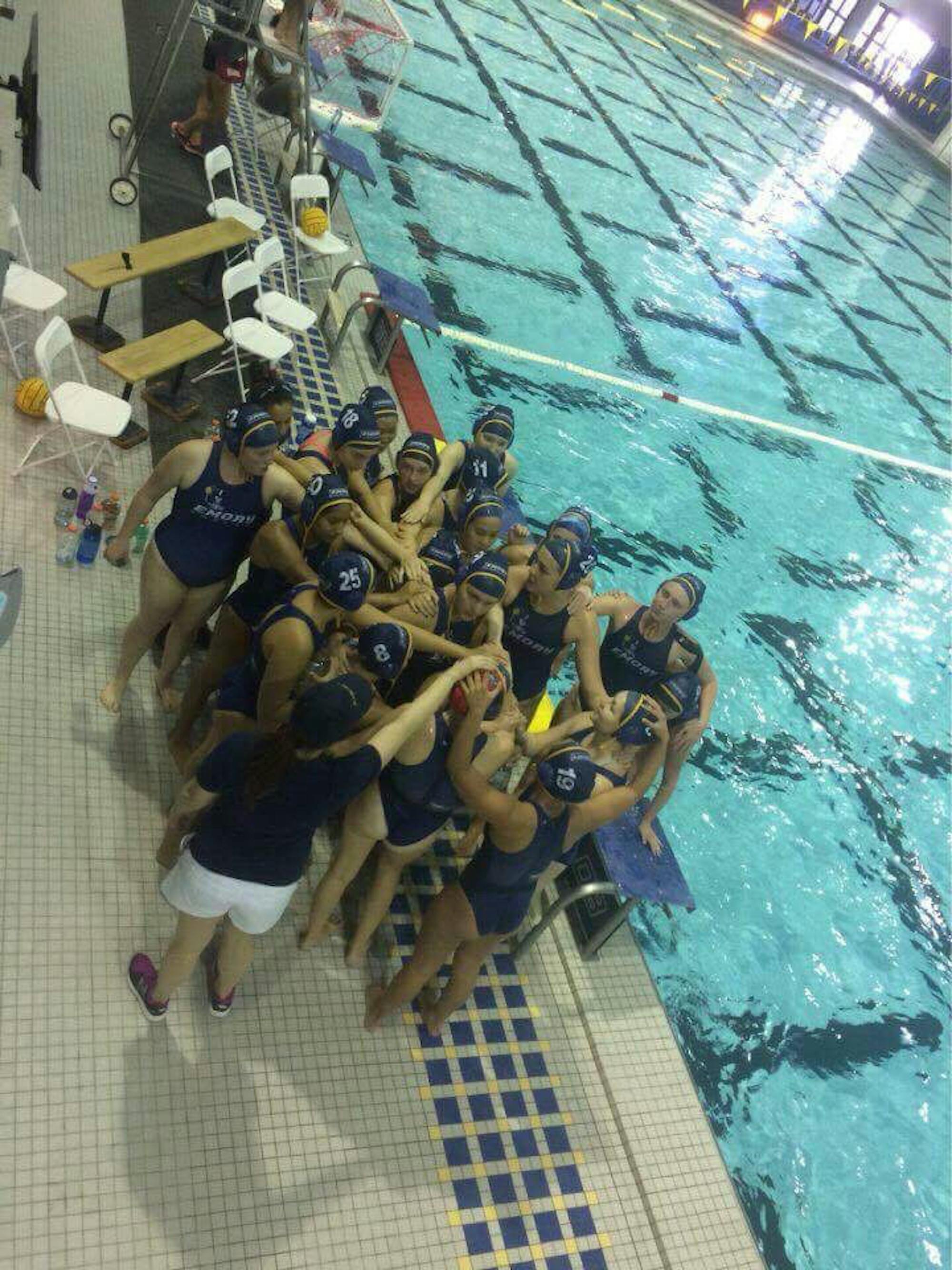 The women's water polo team huddles during the Division Championships. Photo courtesy of Ana Lee Pokrzywa.