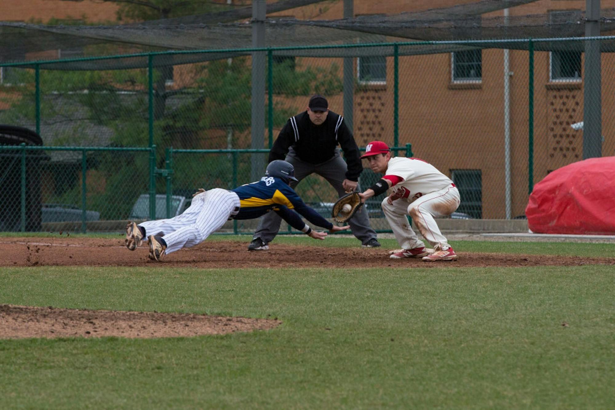 Junior infielder Nick Chambers dives to beat the tag in the Eagles' series at Washington University in St. Louis (Mo.). Photo Courtesy of Grace Burton.