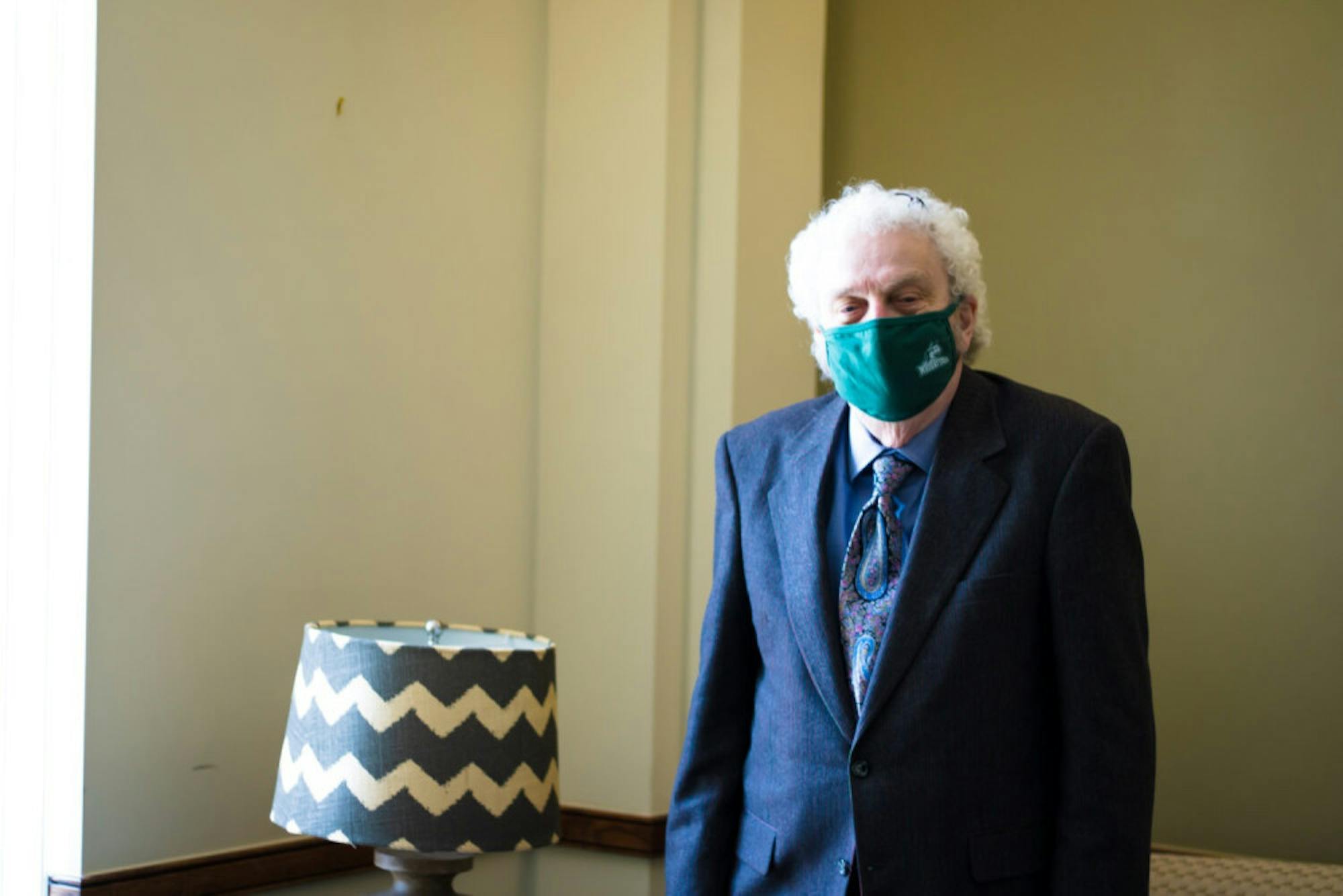 Photo of Oliver H. Evans near a window in his office at Wright State