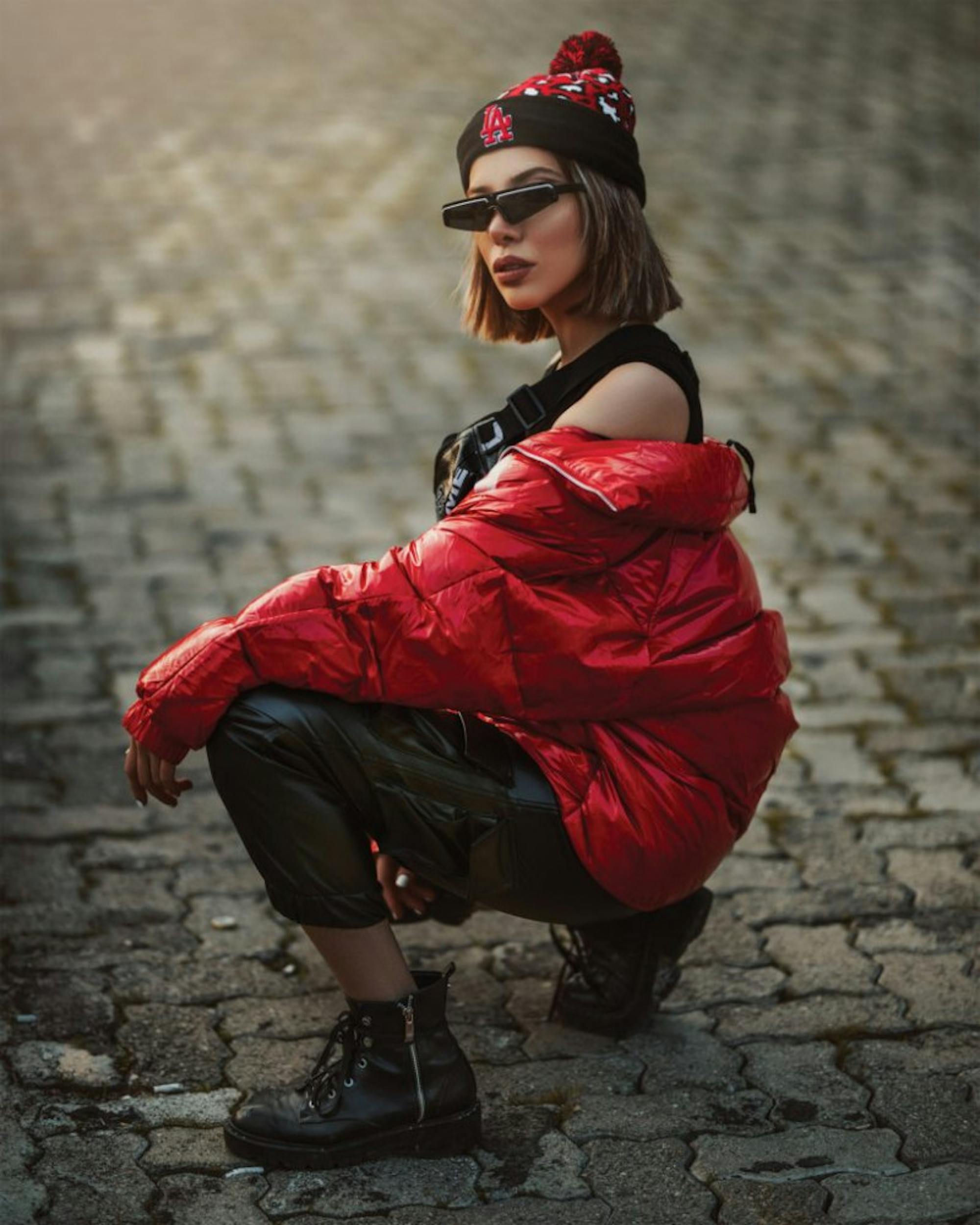 woman-wearing-red-jacket-and-black-sunglasses-sitting-on-3433307-819x1024