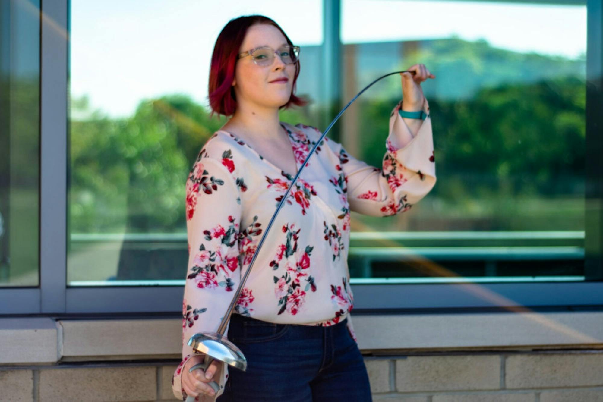 Molly Foster posing with her fencing sword