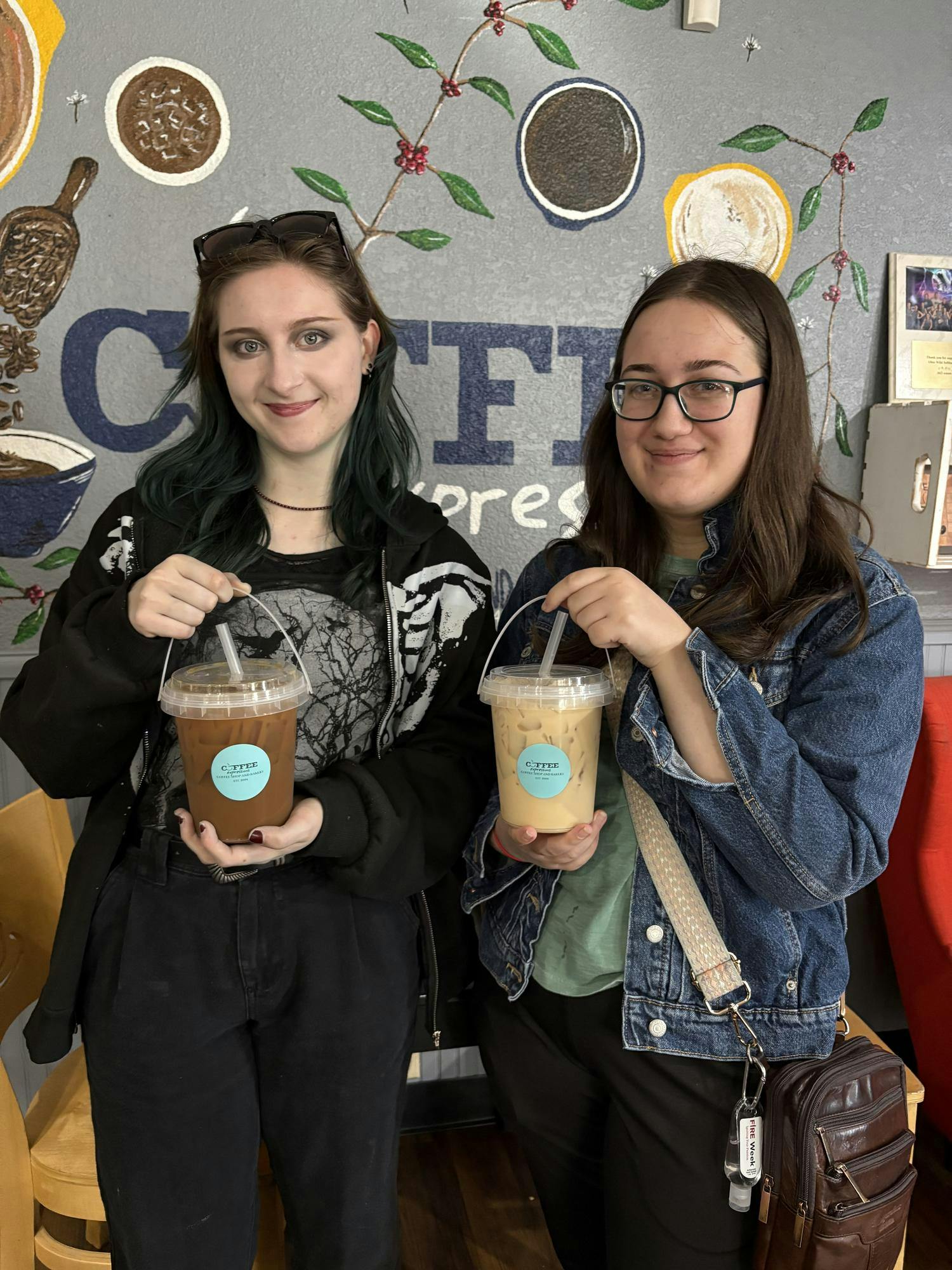 Two students with bucket coffees