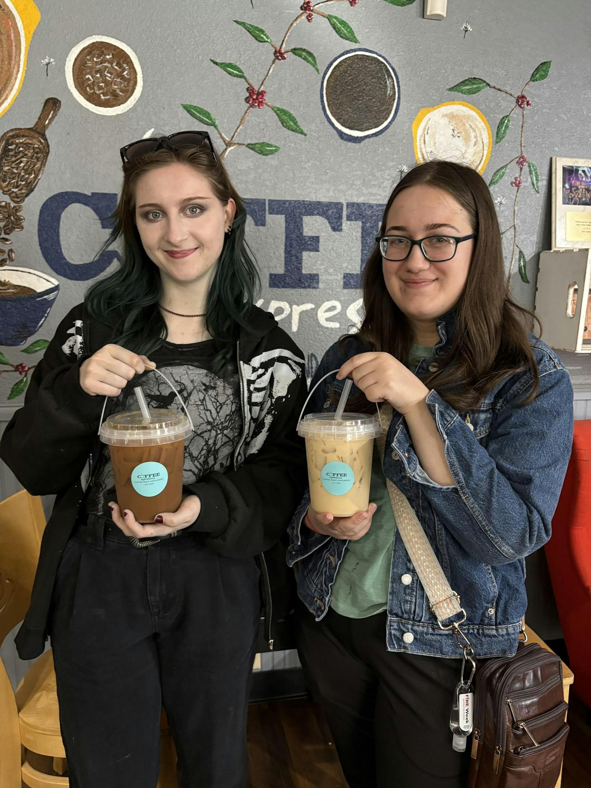 Two students with bucket coffees